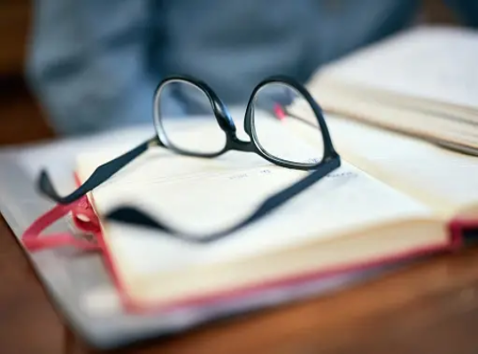 Glasses on top of an open book